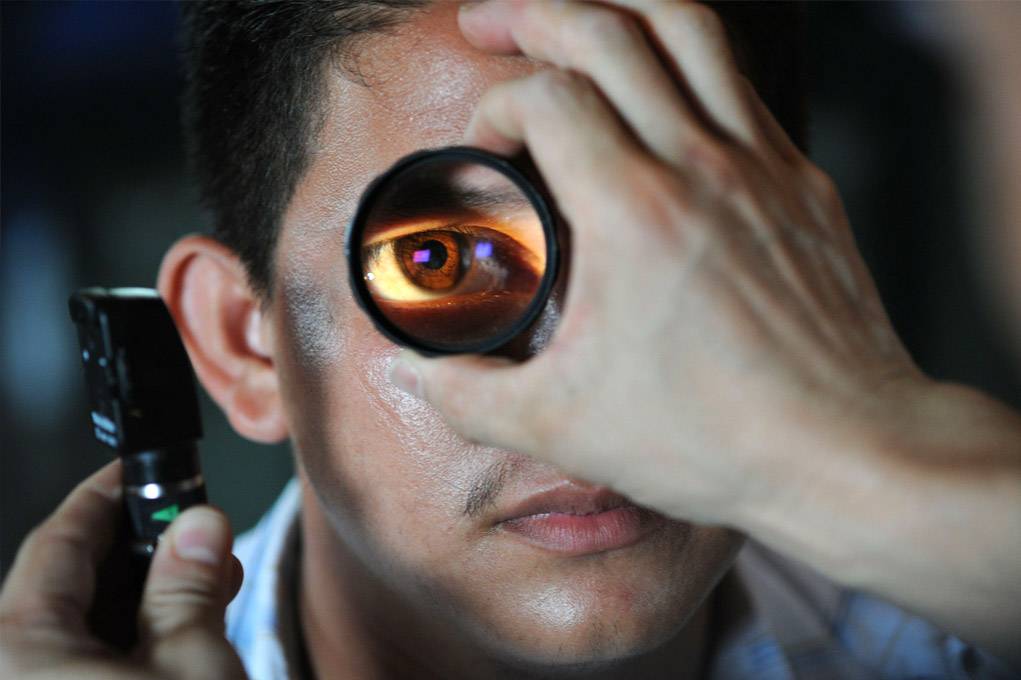 Photo of a man getting a reading eye exam