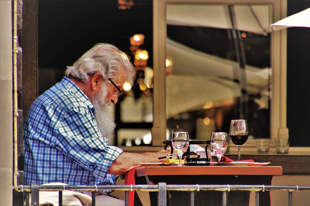 man at table reading