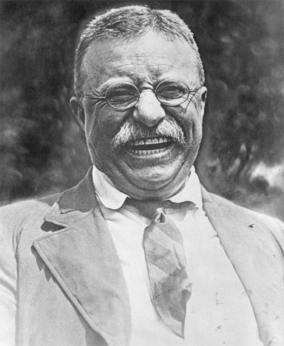 A photo of Teddy Roosevelt donning vintage rimless reading glasses
