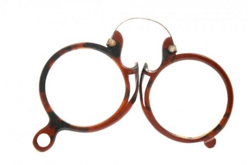 A photo depicting pince-nez on vintage rimless reading glasses