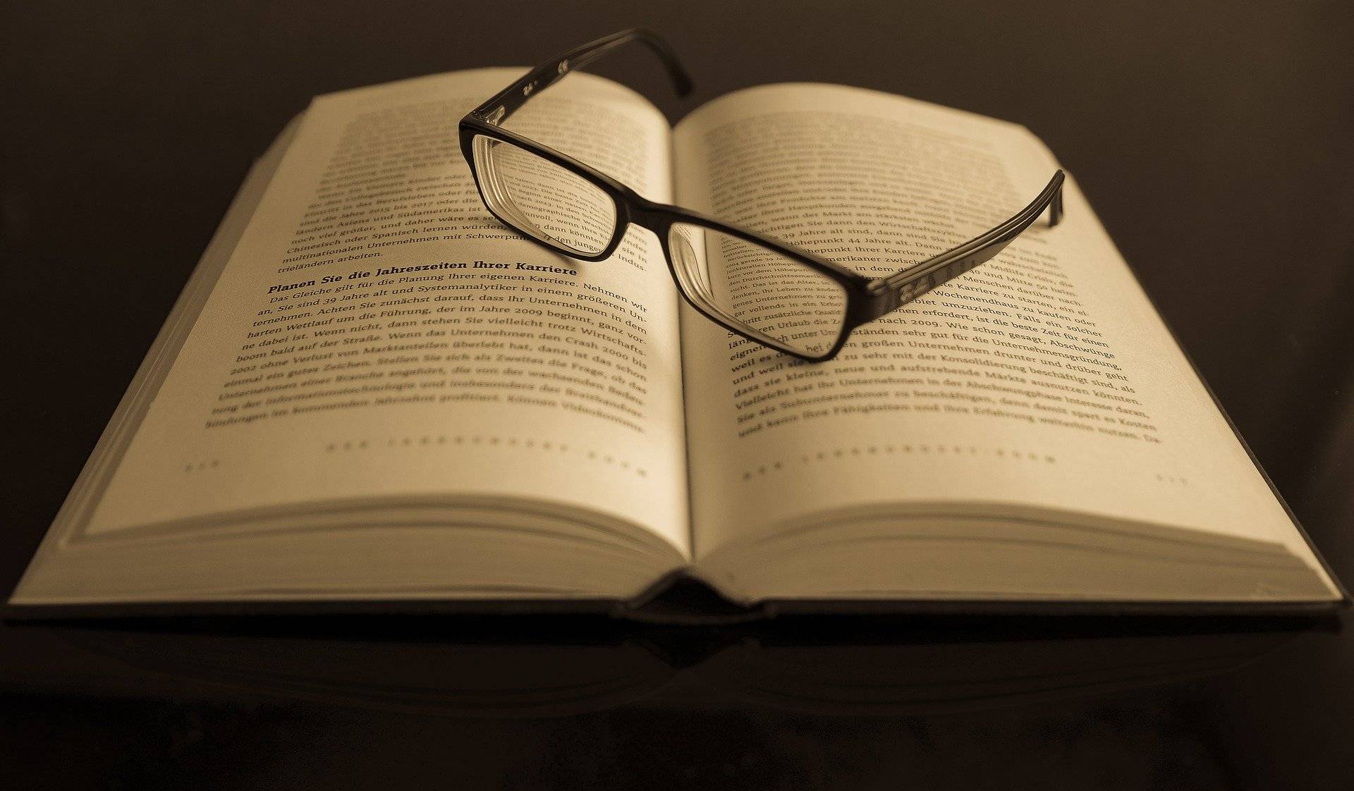 a photo of reading glasses on top of a book